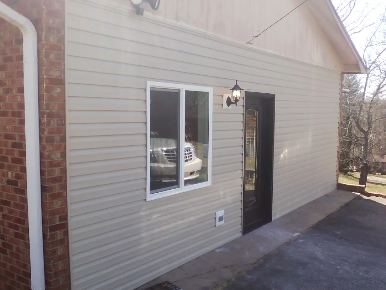 New vinyl siding and entry door on a room addition in Minotola