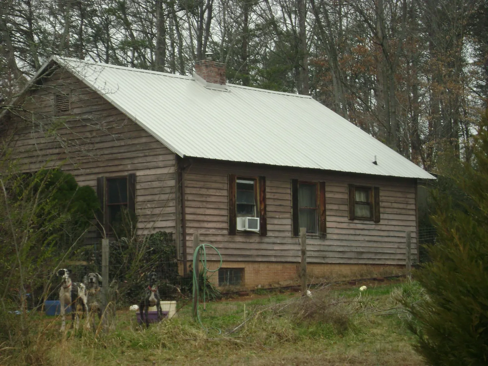White metal roof on an old wood sided farmhouse, from a Metal Roof Installation job in Minotola